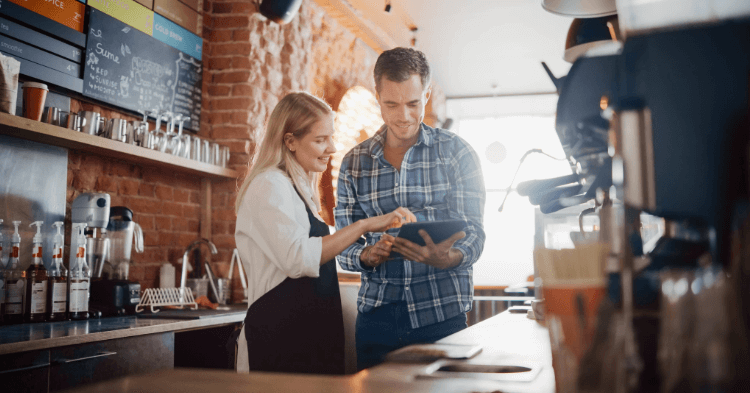 Business owner showing employee an operations manual