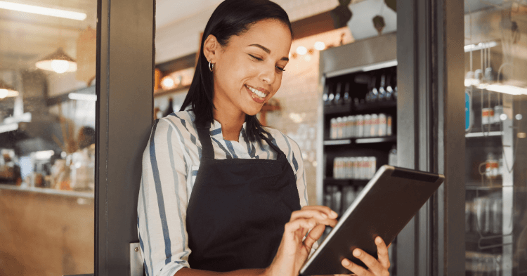 small business owner reviewing a checklist on her tablet