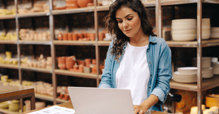 small business owner reviewing her business bank account on laptop