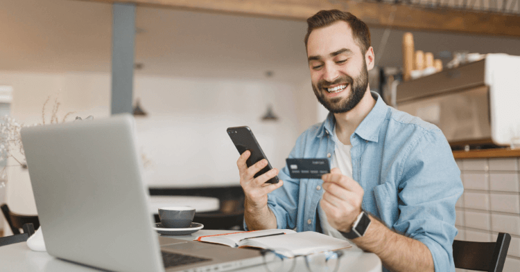 Business man at his laptop with a credit card